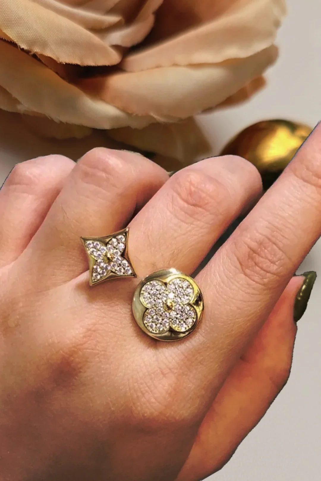 Gold floral and star-shaped crystal ring on hand, Bliss Bymi jewelry accessories