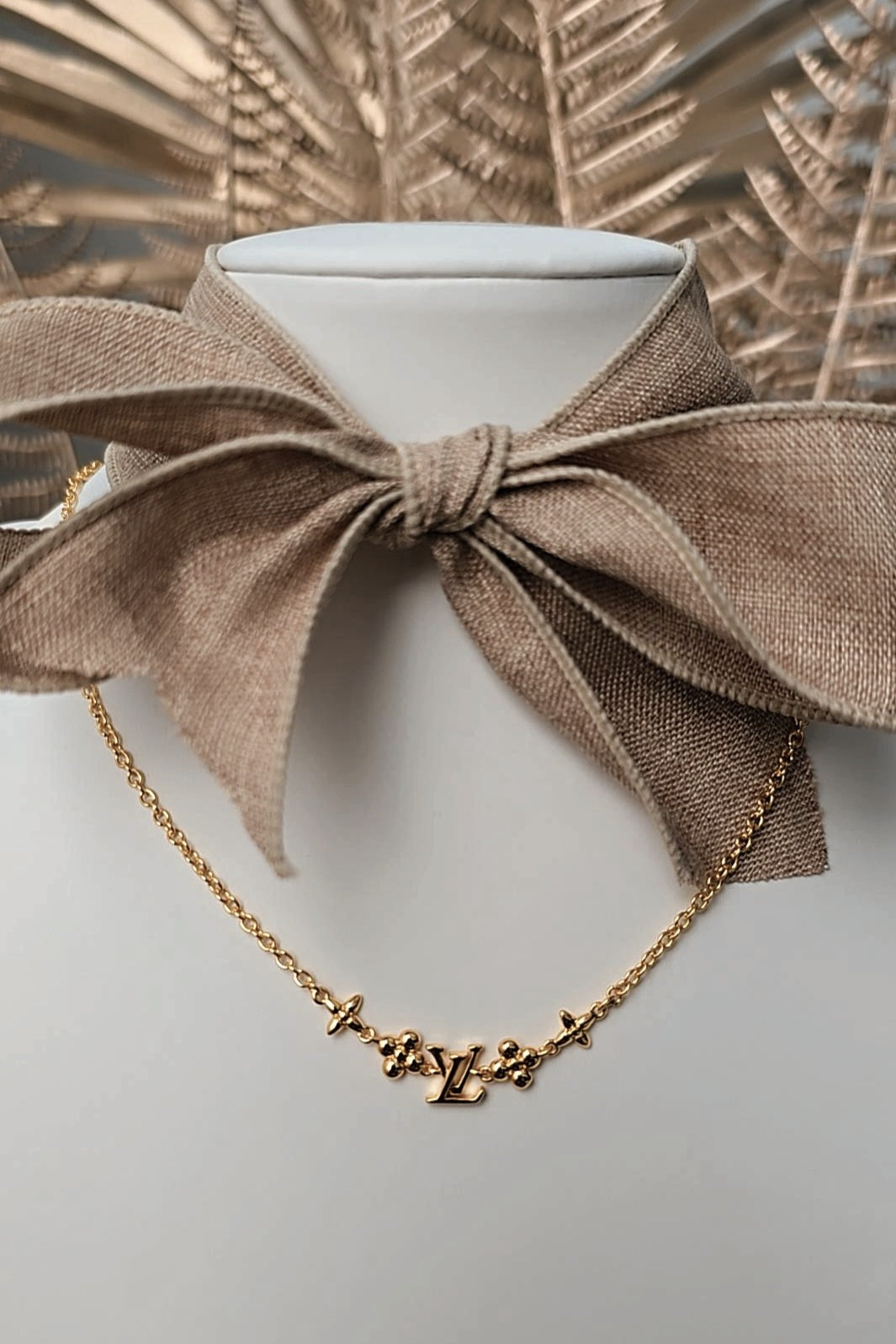Brown bow collar with gold necklace