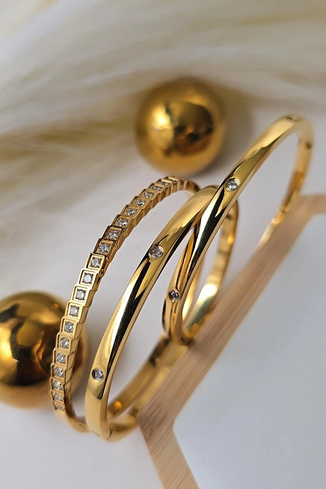 Gold bangles with diamond accents