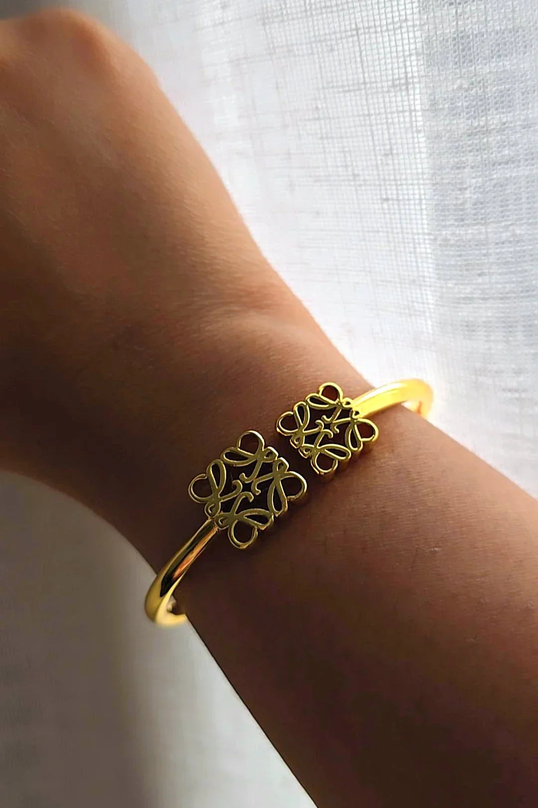 Gold bangle bracelet with intricate design on wrist, Bliss Bymi jewelry for everyday wear