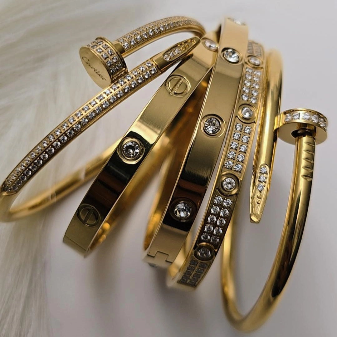 Gold bangles with diamond accents on a light background