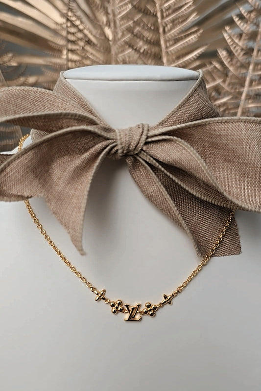 Brown bow collar with gold necklace