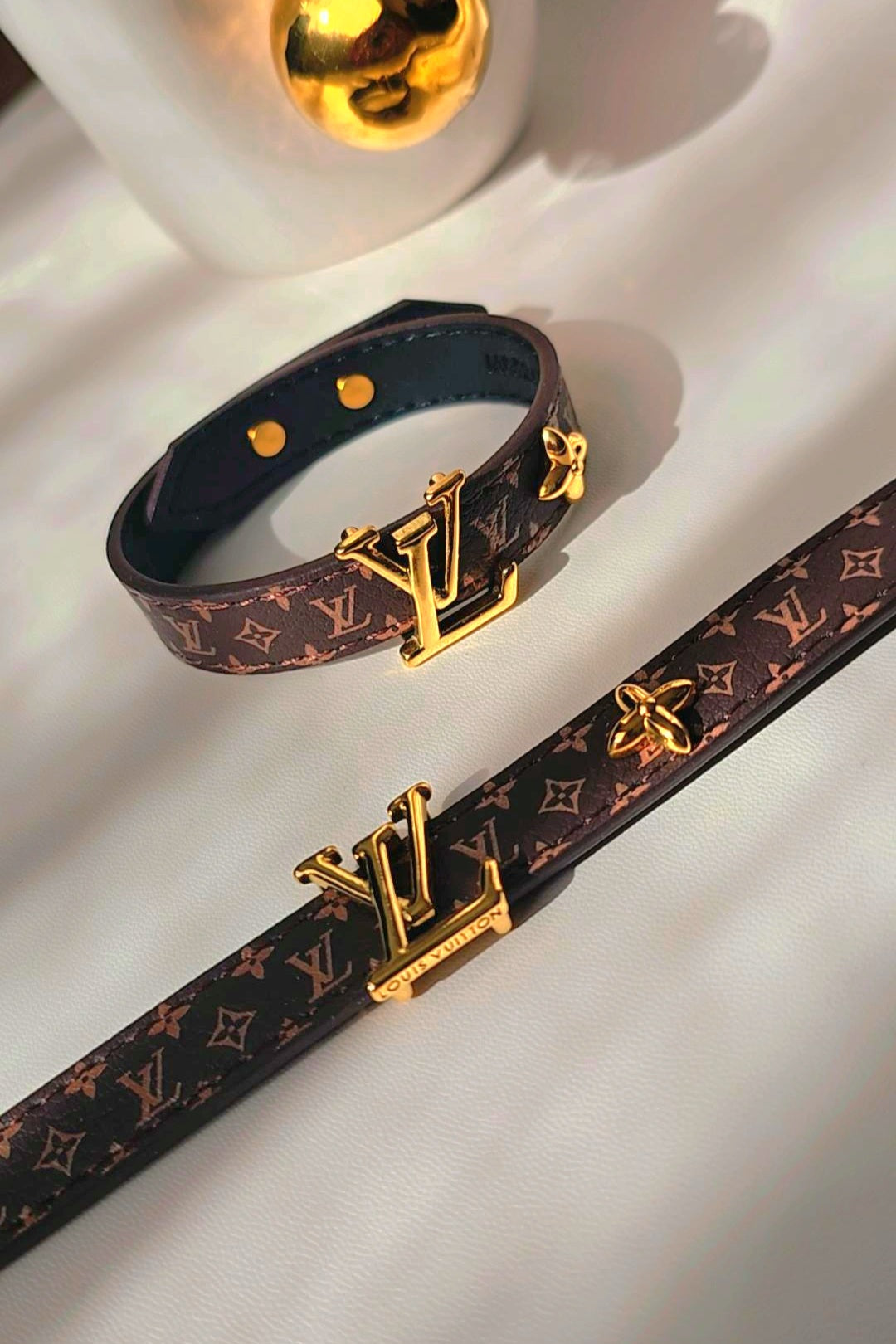 Louis Vuitton belt and bracelet with monogram pattern