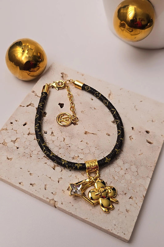 Black and gold bracelet with charms