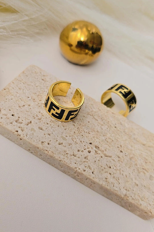 Gold hoop earrings with black geometric design