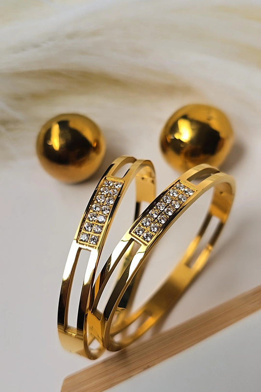 Gold bracelet with diamond accents on a light wooden surface