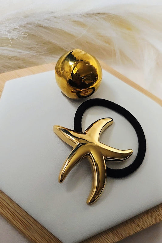 Gold starfish-shaped hair clip and gold ball 