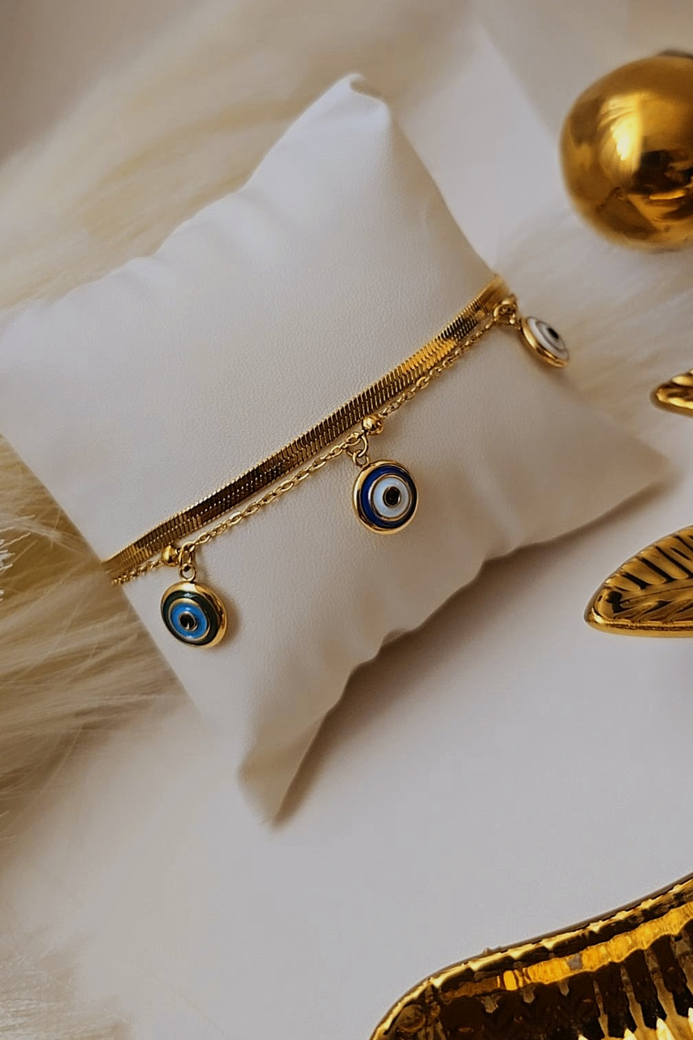 Gold bracelet with blue eye charms 